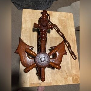Vintage wooden nautical wall hanging featuring an anchor and ship's wheel